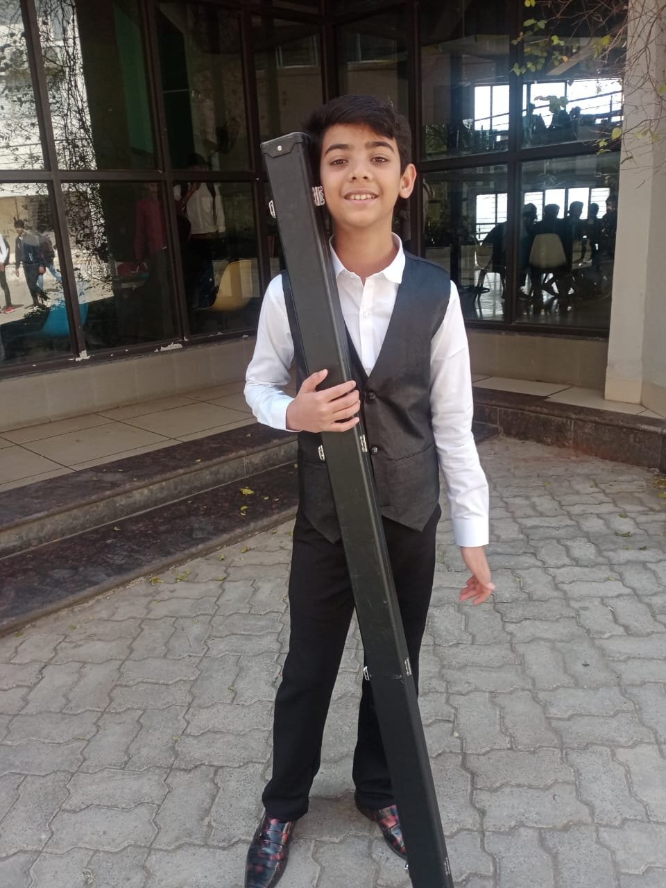 Young Rahul Williams with his snooker cue case