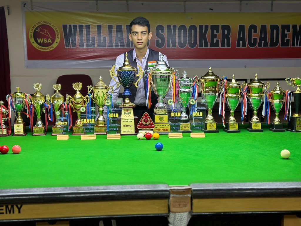 Rahul Williams with a collection of trophies on the snooker table at Williams Snooker Academy, Coimbatore
